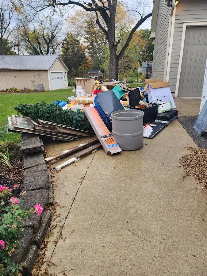 Dumpster being loaded with debris for 12 Yard Dumpster Rental in Upper Dublin